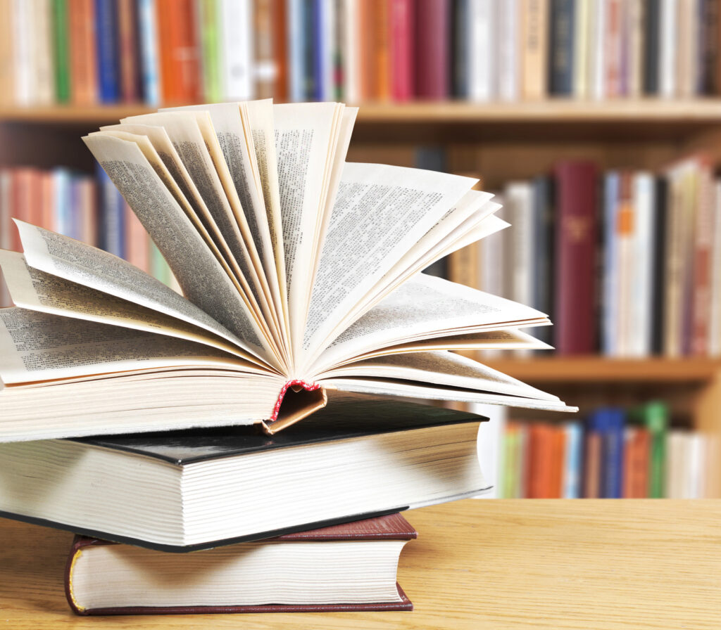 A pile of books with library on the back